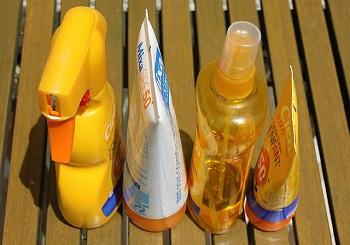 Four different sunscreens sitting on a table
