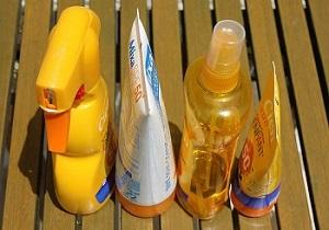 4 bottles of sunscreen sitting on a table