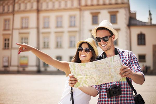 Travel Immunizations Image - Couple traveling with map