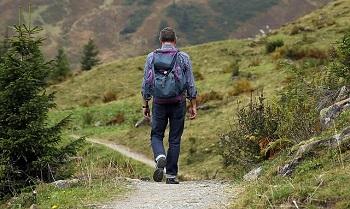 Man with backpack hiking in mountains